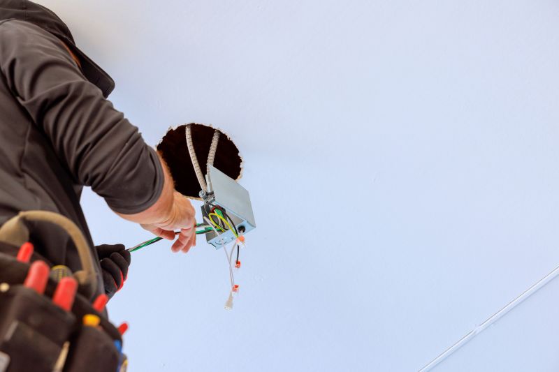 Electrician Installing a Light Fixture